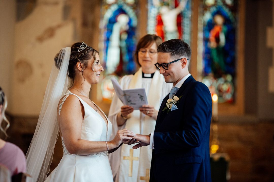 Couple sharing emotional moment during traditional church wedding ceremony.