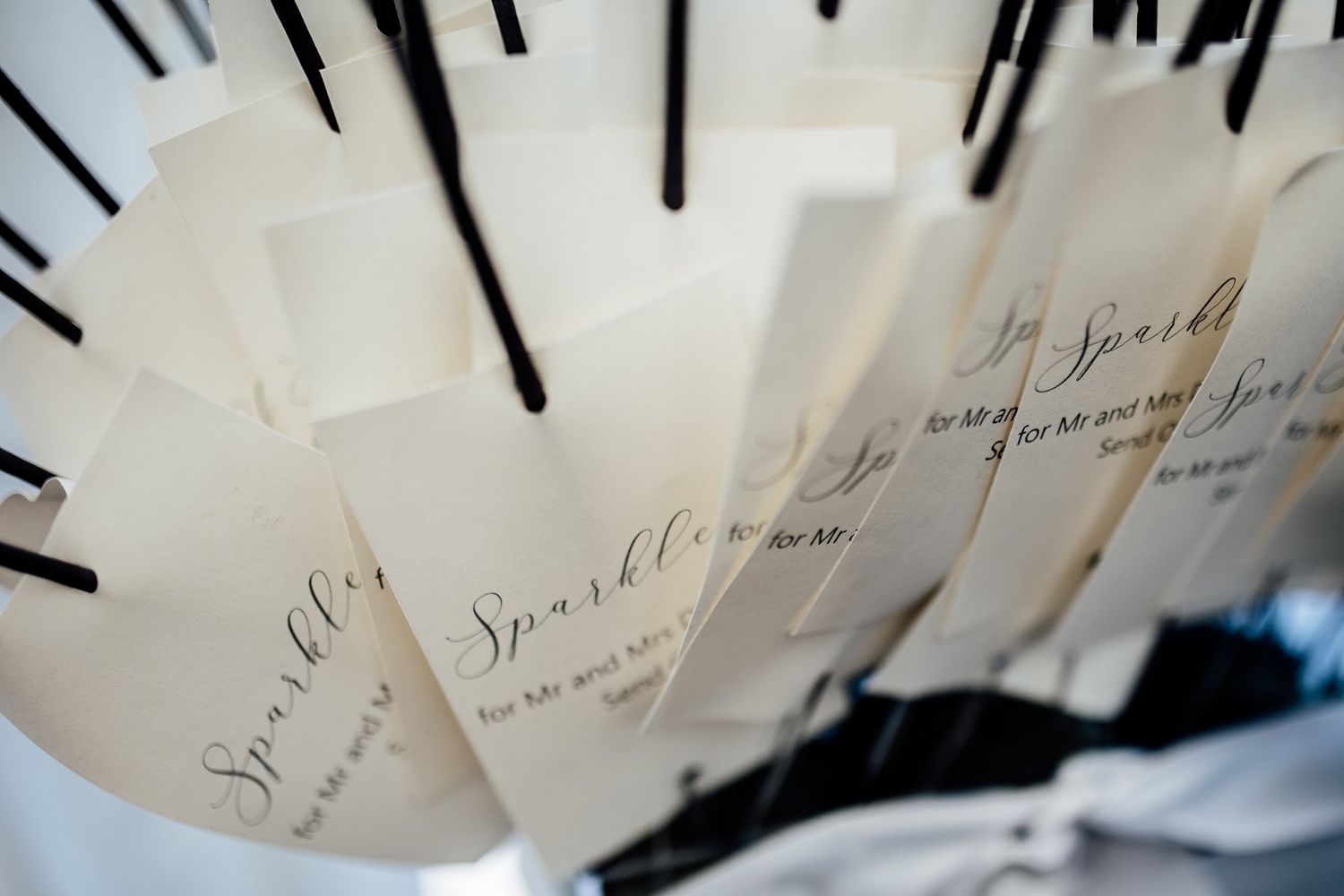 Wedding place cards arranged in artistic display with black accents.