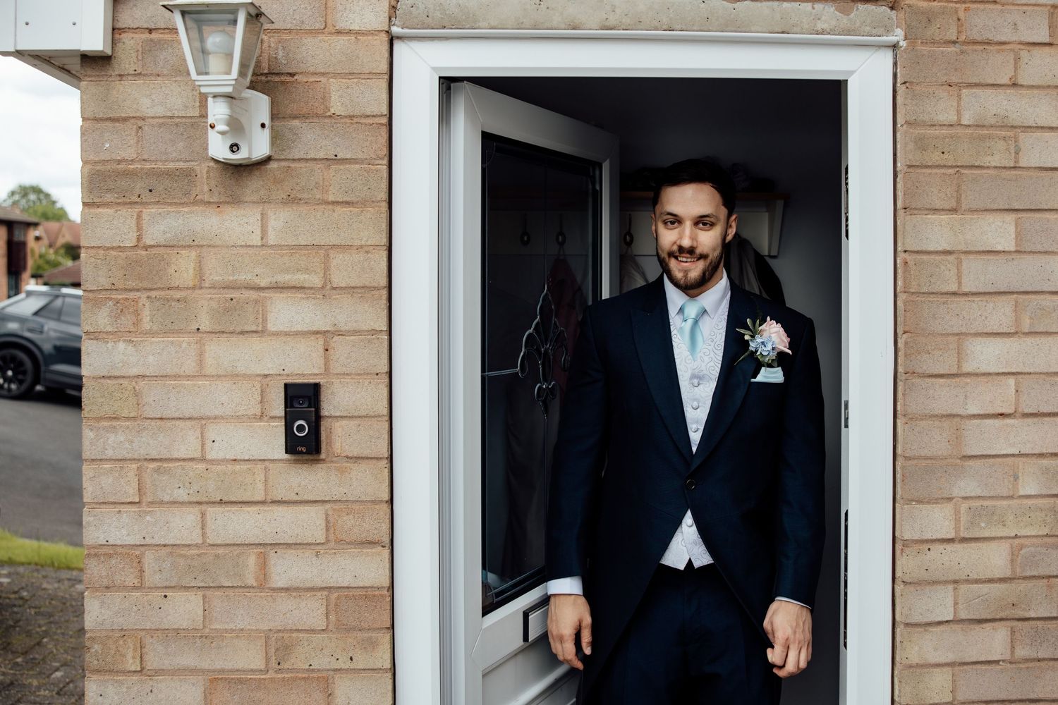 Elegant wedding venue exterior with brick walls and white trim windows.
