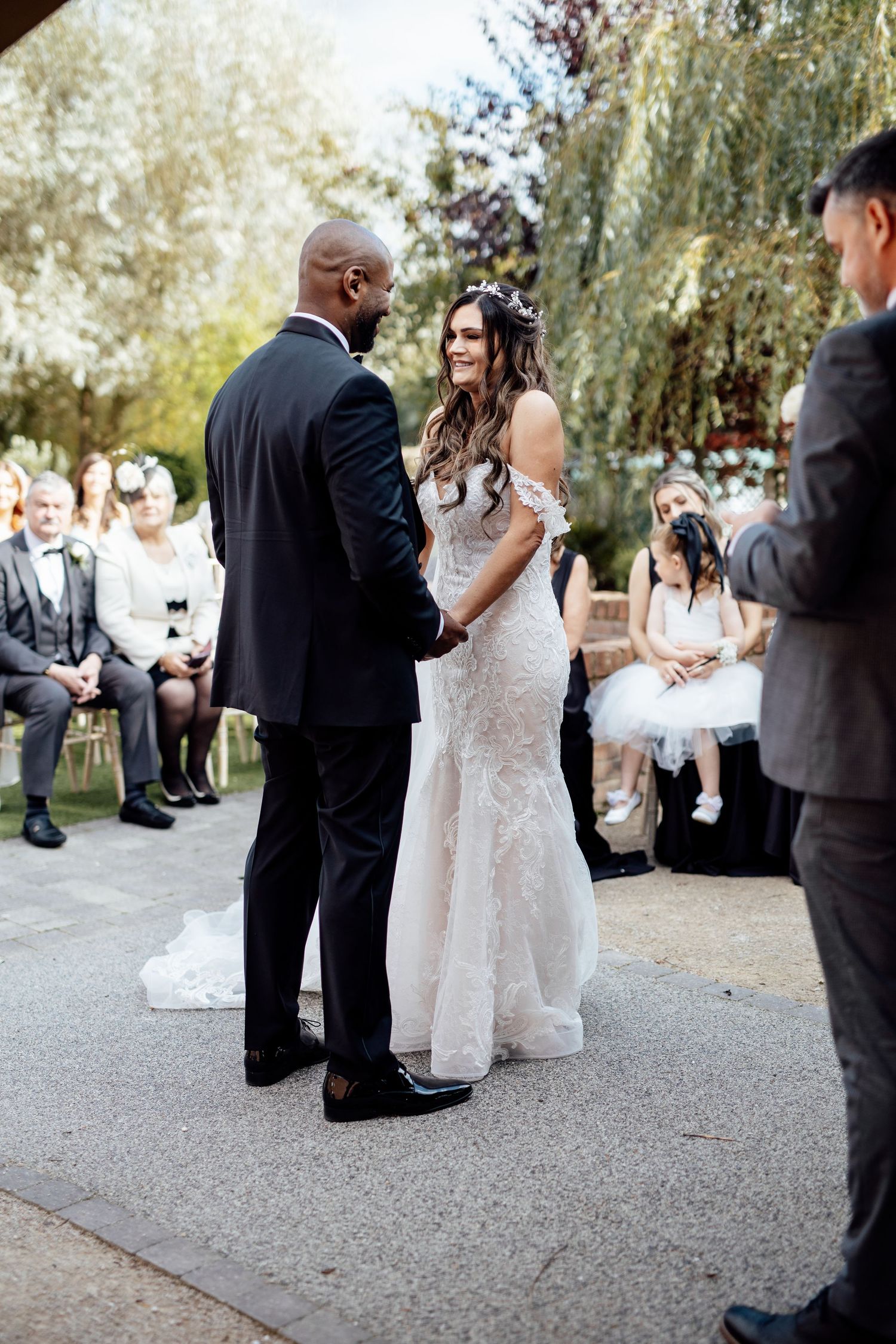 Wedding guests and bridal party mingling during outdoor reception.
