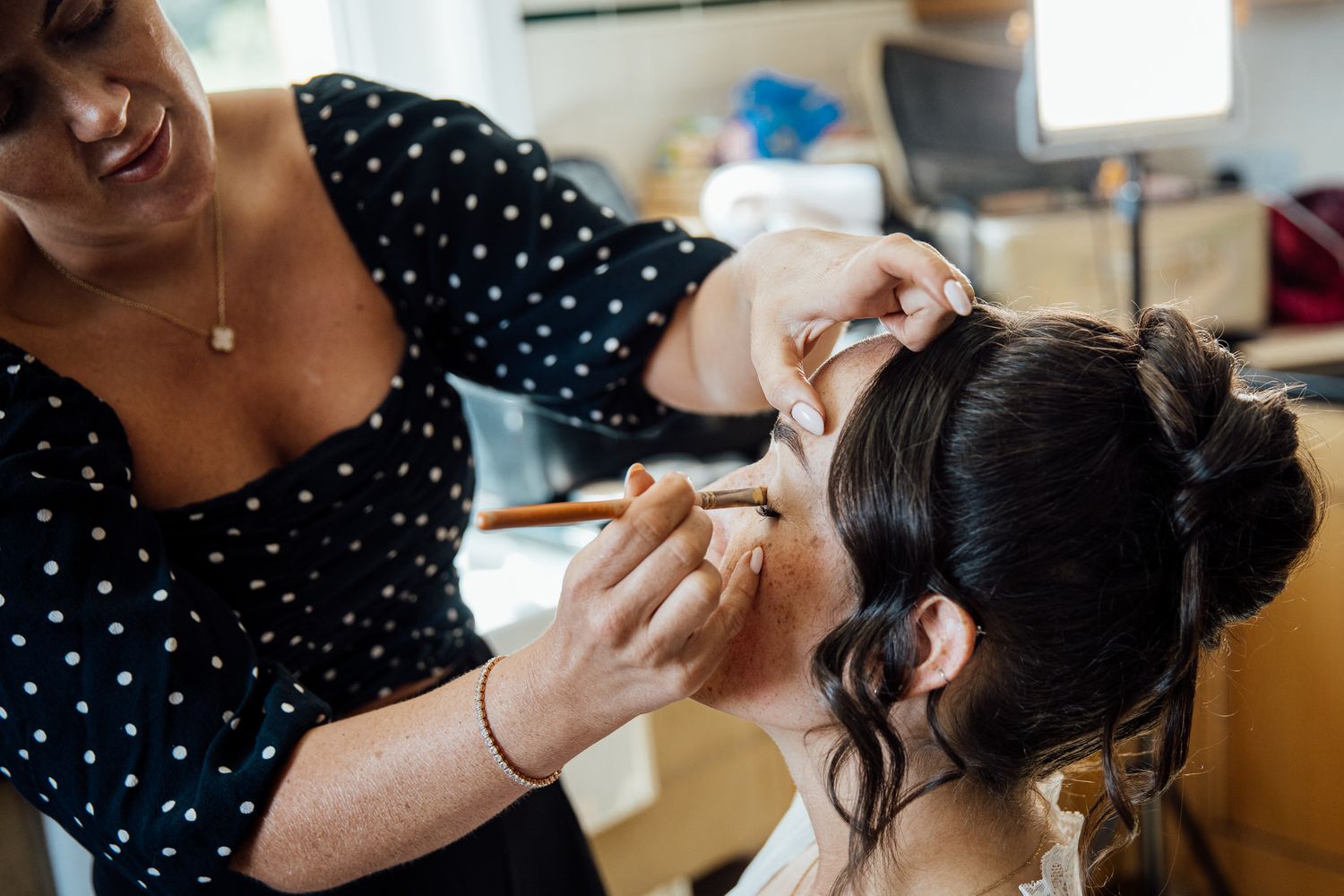 Hair styling preparations during wedding day getting ready moments.