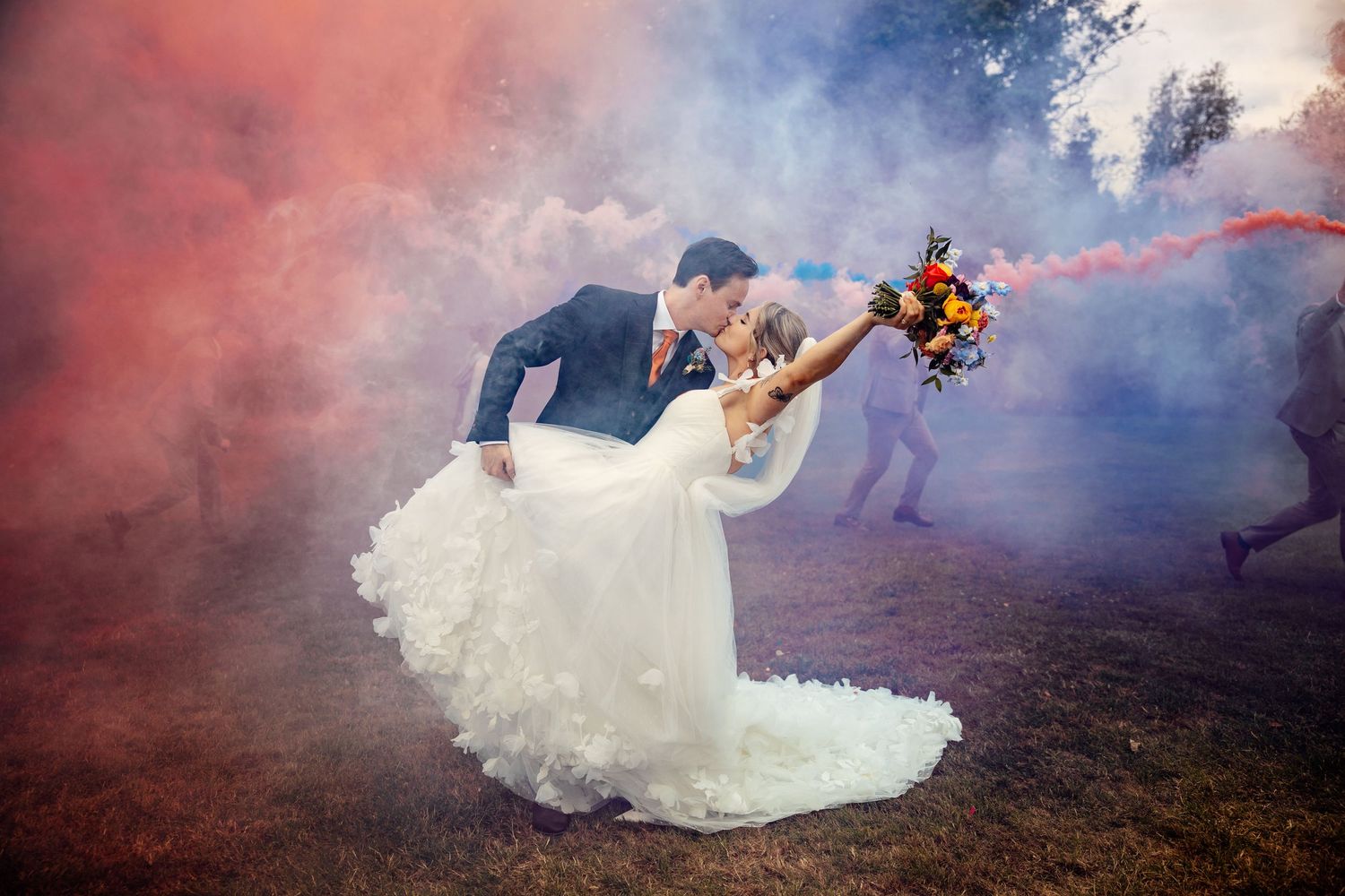 Dramatic smoke bomb photography session with flowing white wedding dress.