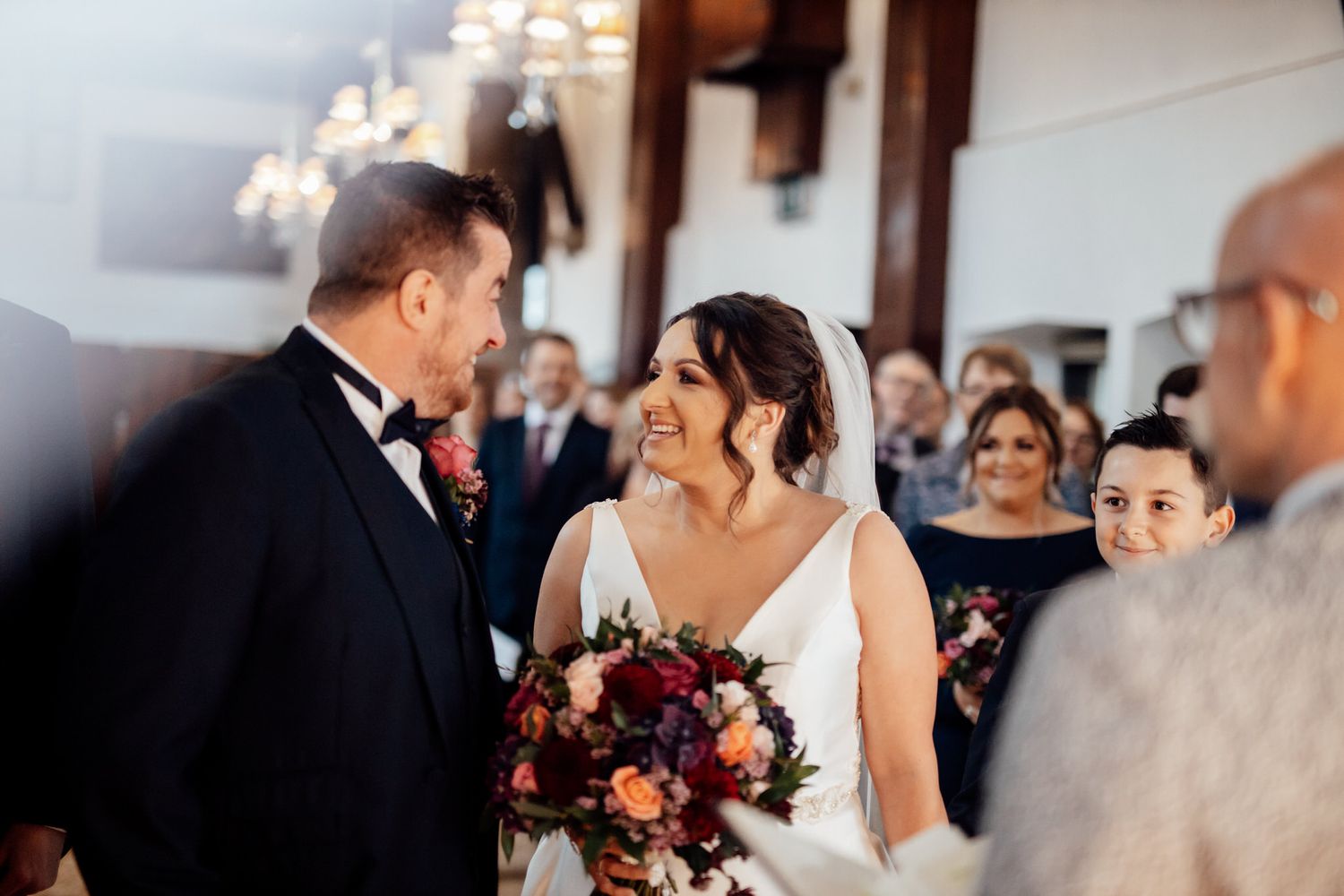 Wedding celebration with elegant table settings and floral arrangements.