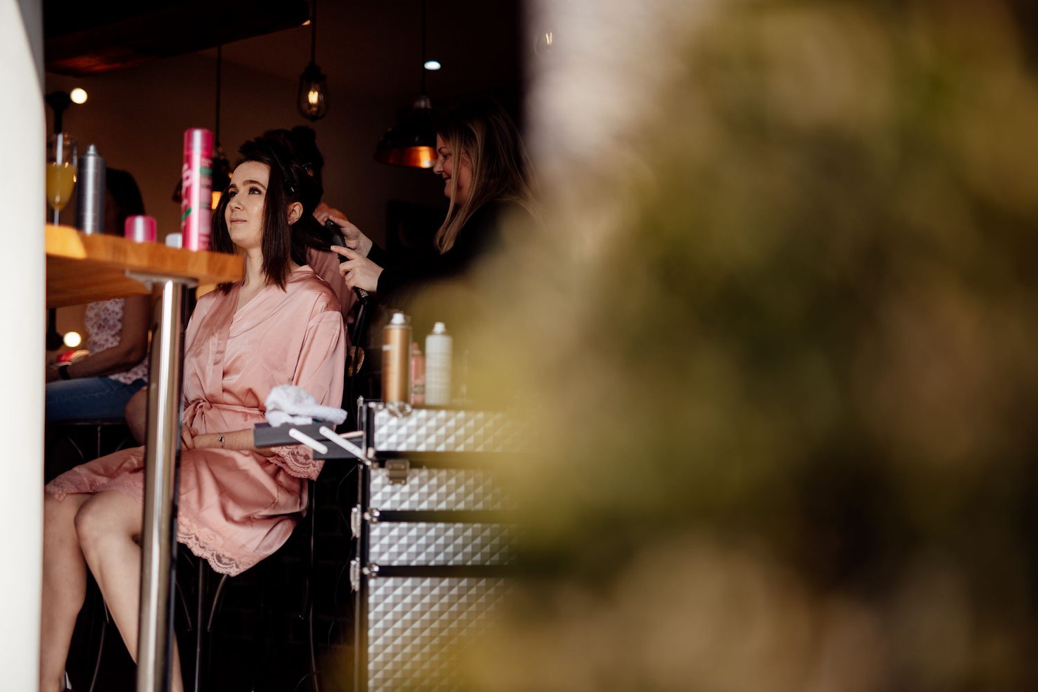 Candid moments captured during wedding preparations in an intimate indoor setting.