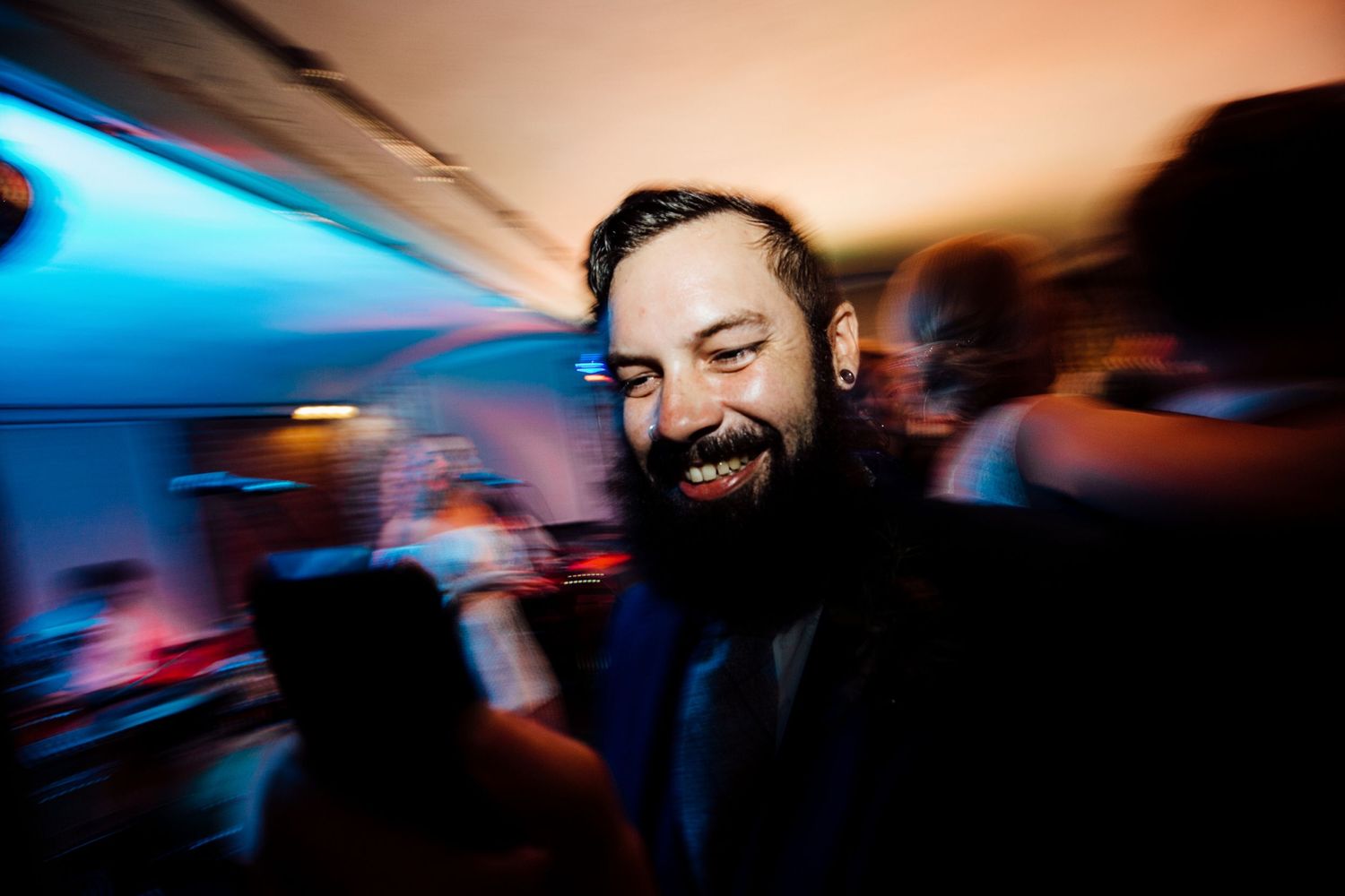 Party guest enjoying the celebration with motion blur and blue lighting effects.