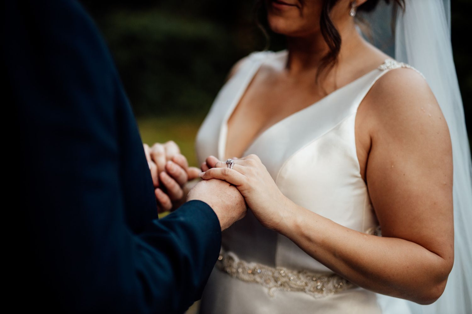 Close-up shots of a couple holding hands during their wedding ceremony.