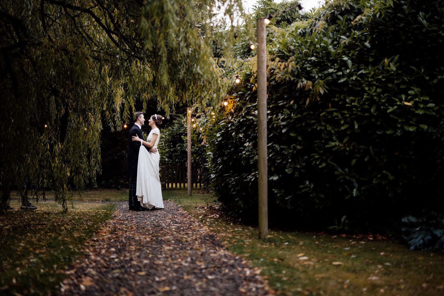 A romantic wedding photoshoot among autumn trees and falling leaves.