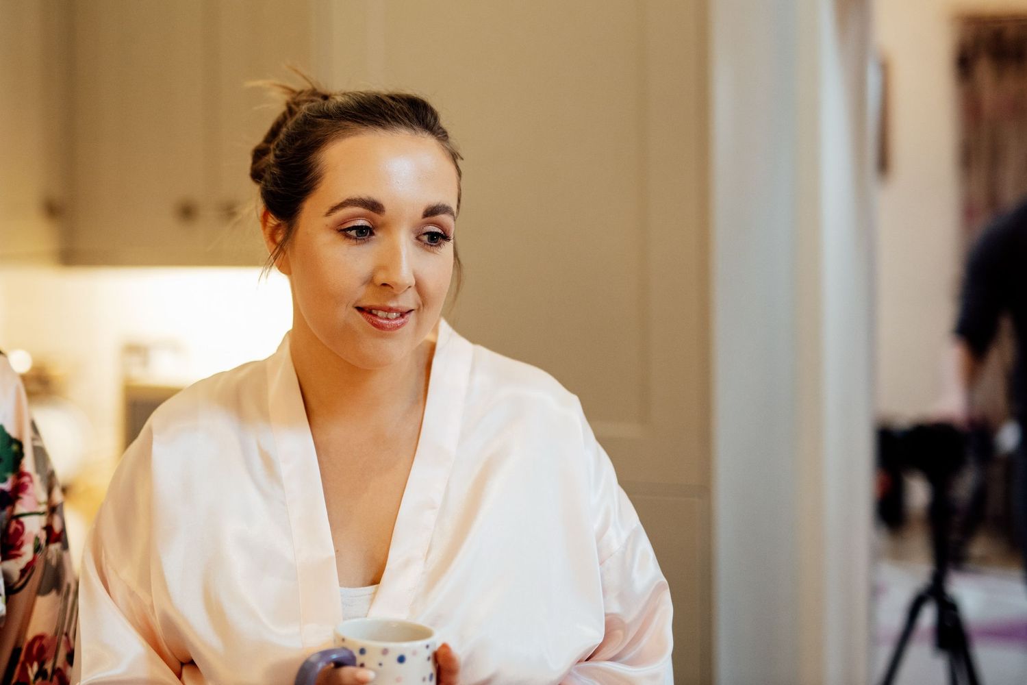 Bright indoor preparation room with white robes and natural window light.