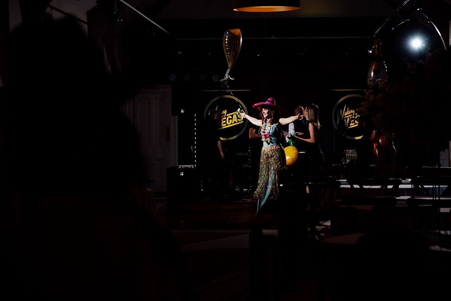 Dramatic stage lighting illuminates performers during an evening entertainment show.