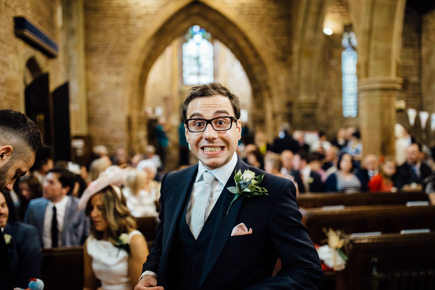 Wedding ceremony in a grand cathedral with arched stone architecture.