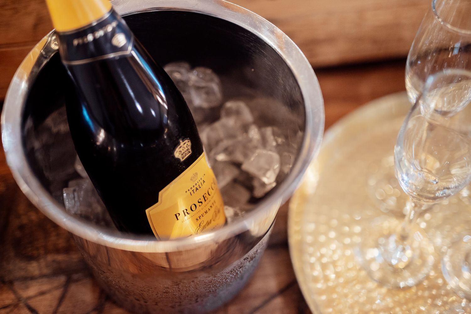 Champagne bottles chilling in ice buckets at an elegant wedding reception.