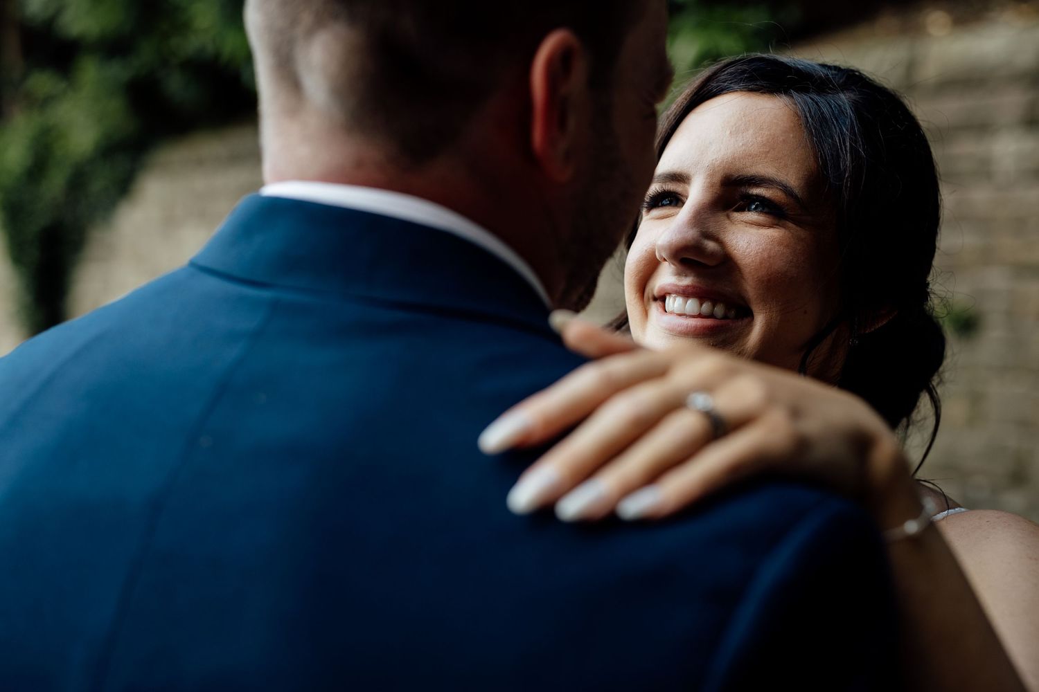 Romantic embrace captured in natural outdoor setting.