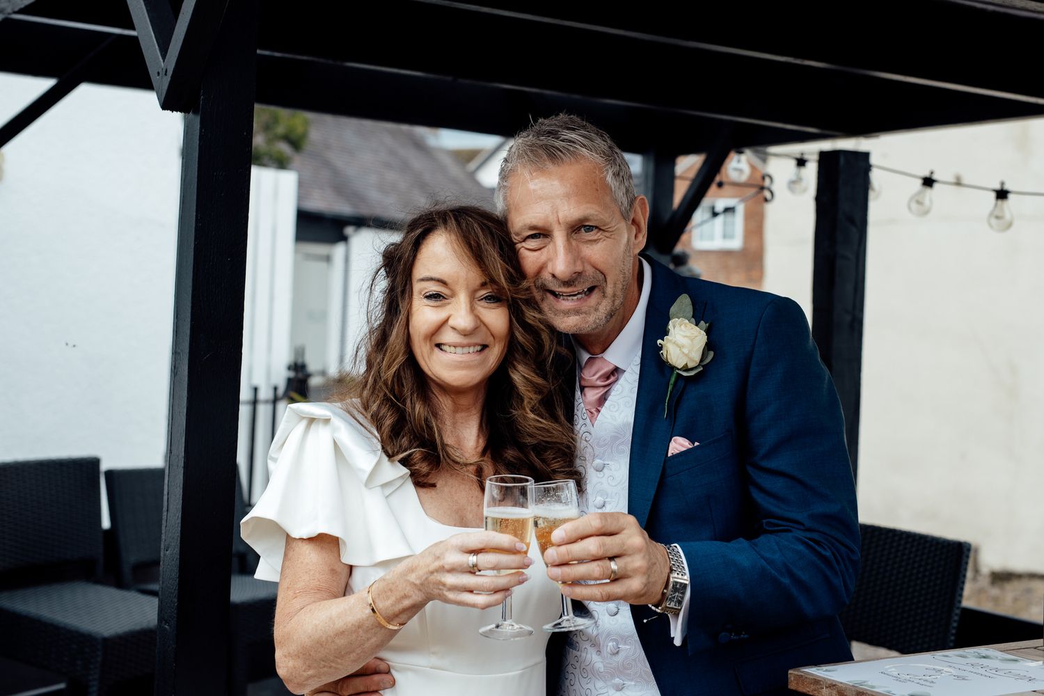 Couple shares intimate moment while toasting with champagne glasses.