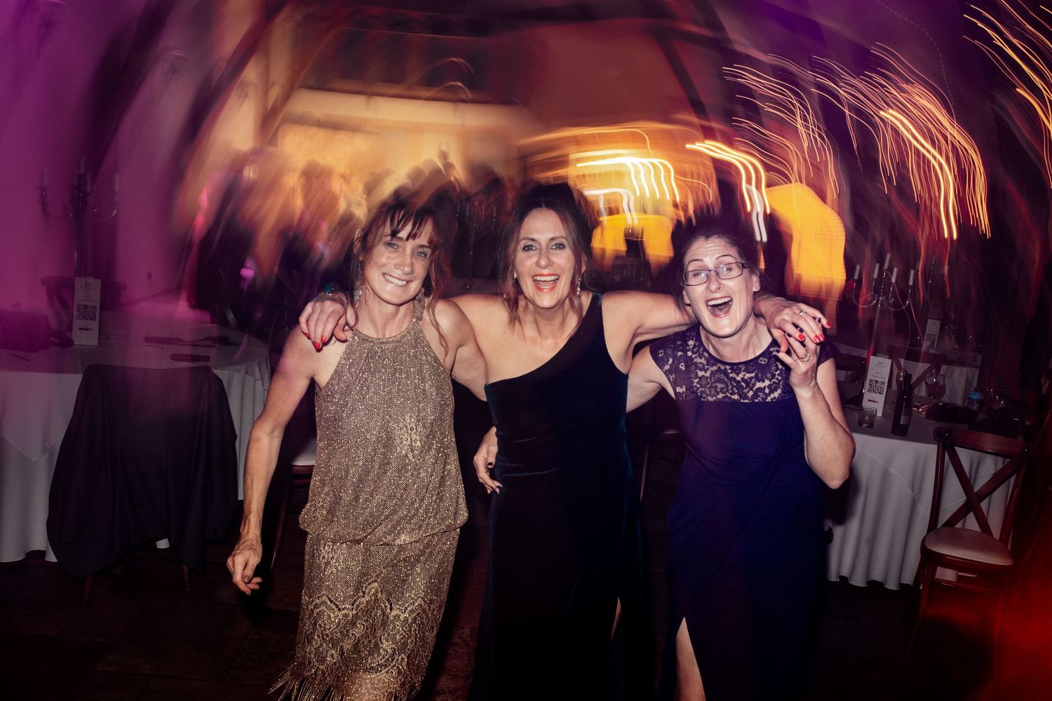 Wedding reception dance party with purple mood lighting and energetic atmosphere.