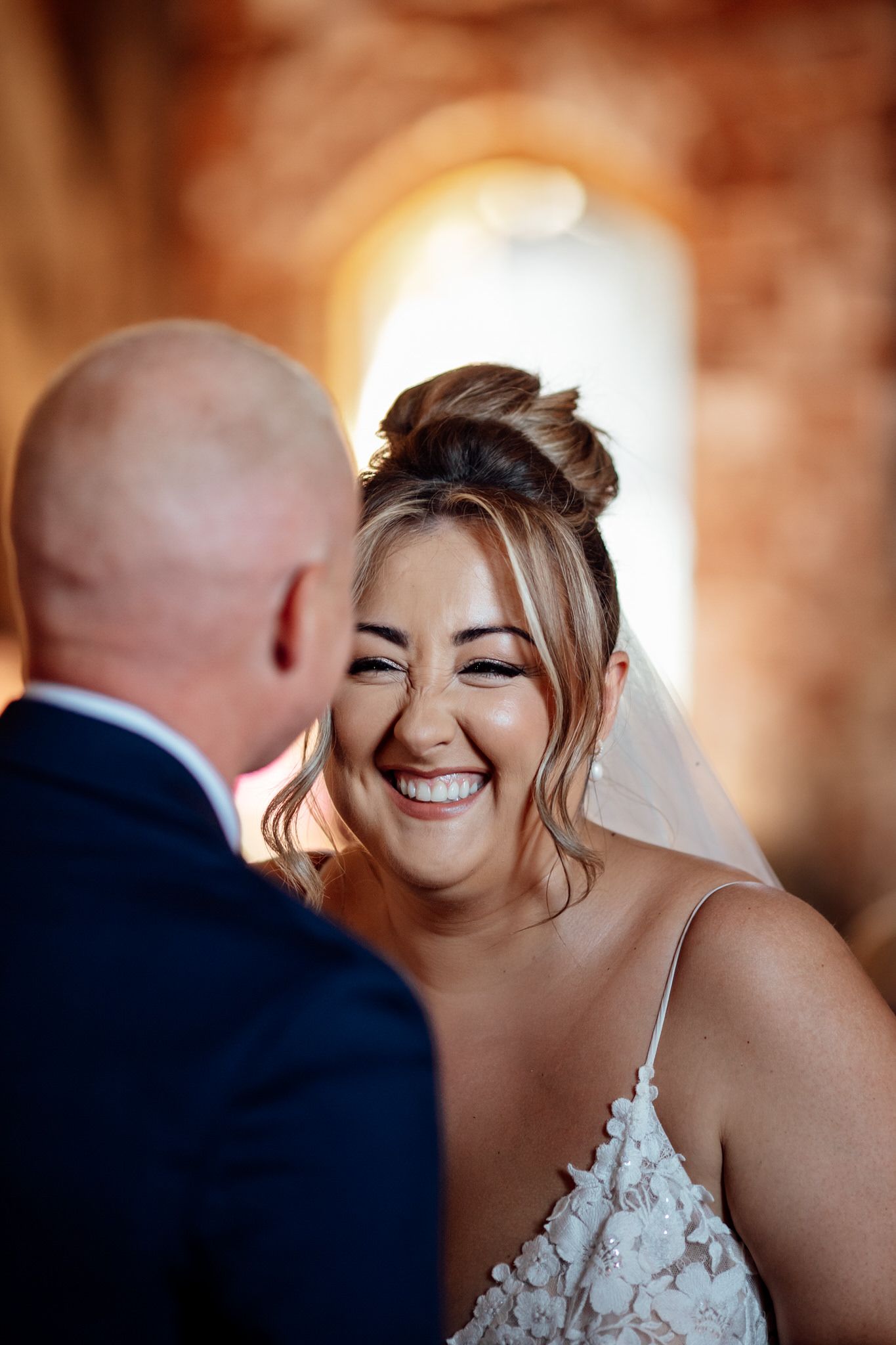 Wedding celebration in a rustic brick venue with warm lighting and joyful moments.