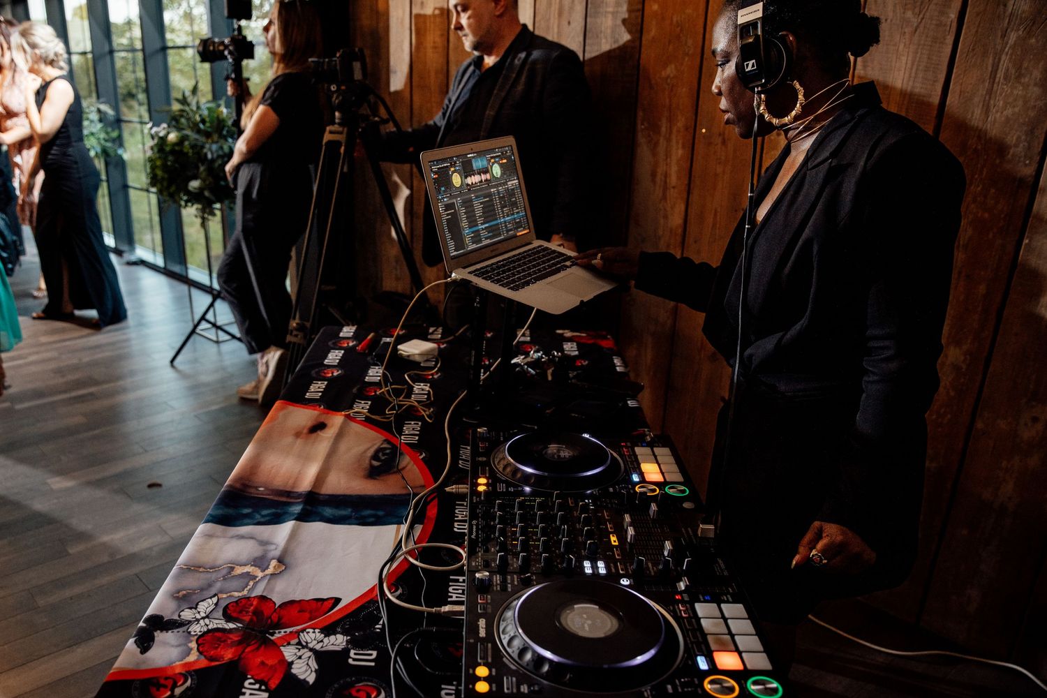 DJ setup and equipment at an event venue with mood lighting.