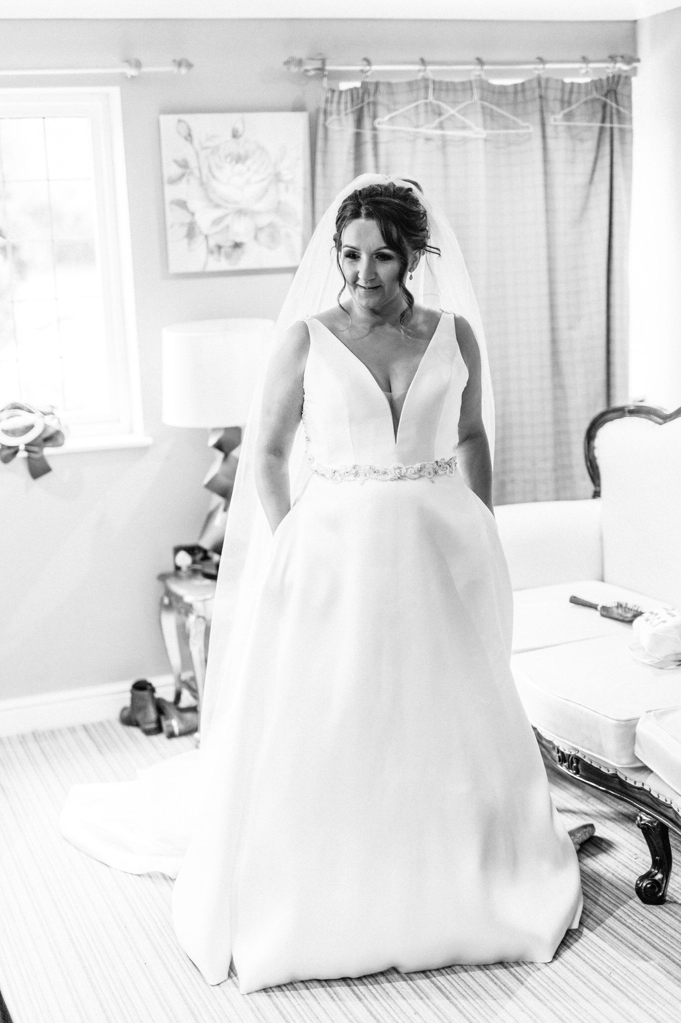 High-key bridal preparation photos showing elegant white wedding dress details.