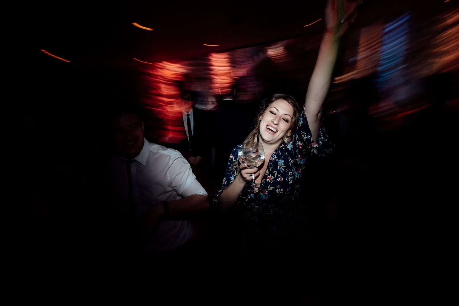 Dynamic dance floor scene with motion blur and red lighting effects.