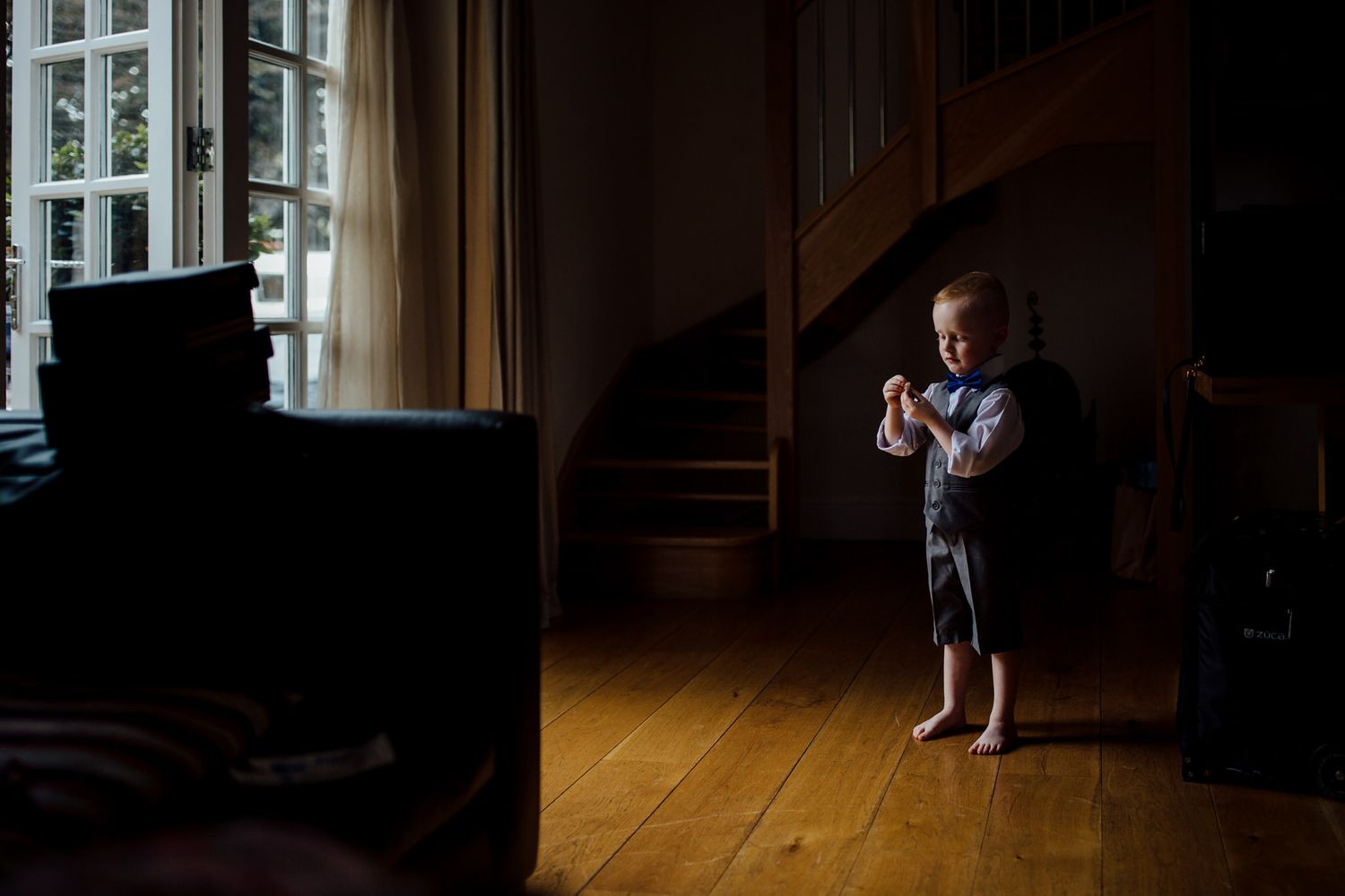 Dramatic window lighting in an empty room creates moody shadows and atmosphere.