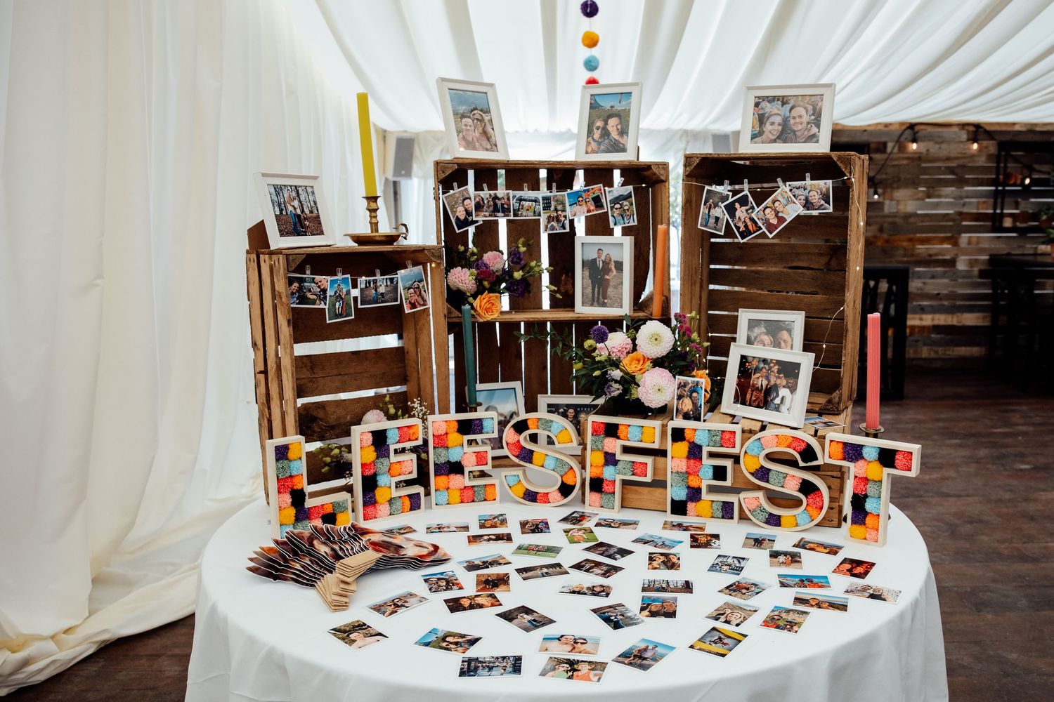 Wedding guest book table decorated with wooden letters and vintage photographs.
