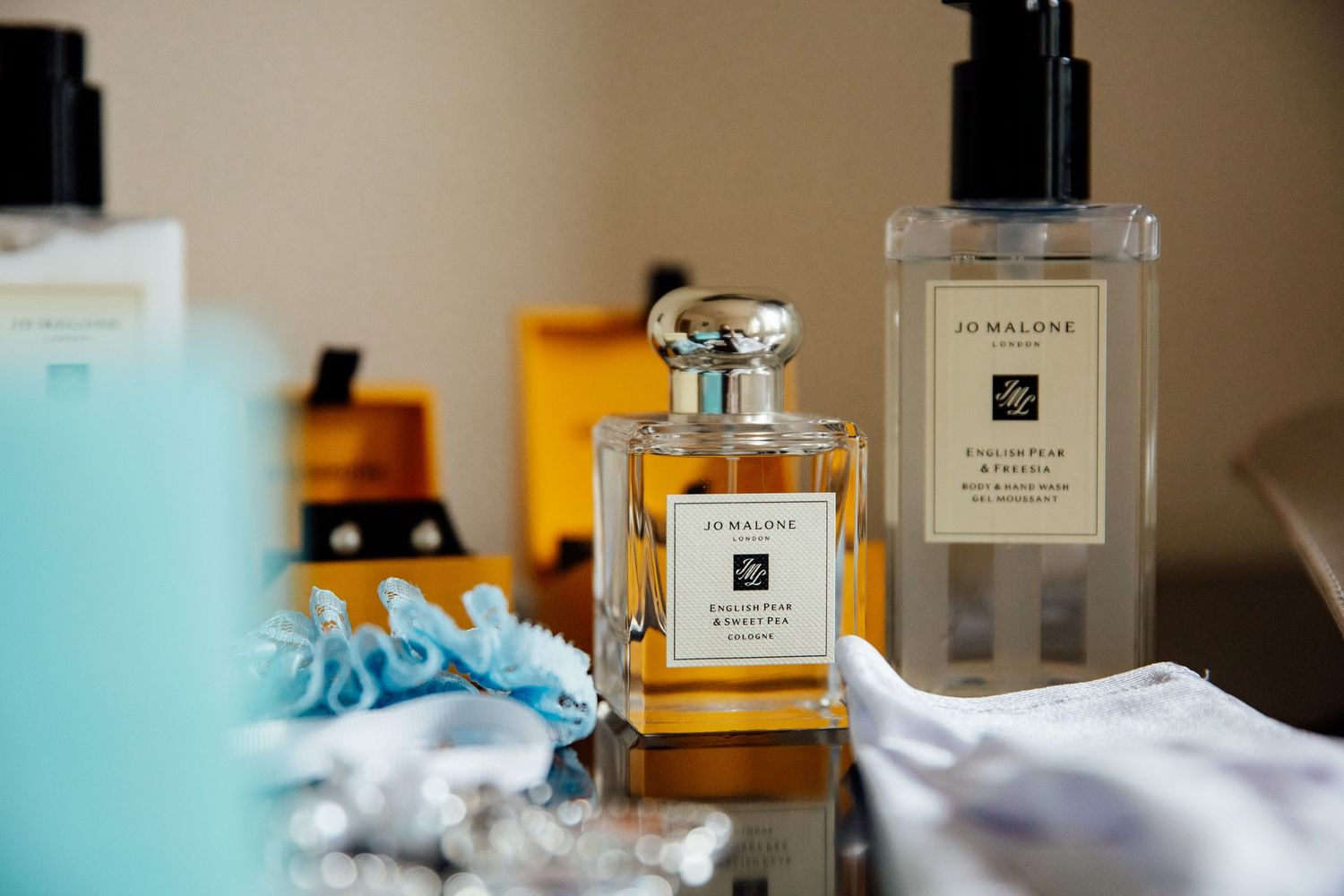Collection of luxury perfume bottles arranged on wedding day vanity.