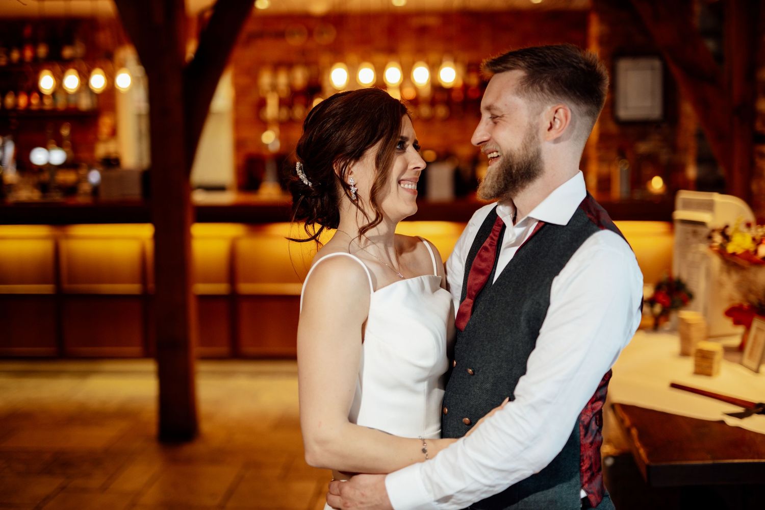 Romantic evening dance moments captured at a warmly lit wedding reception.