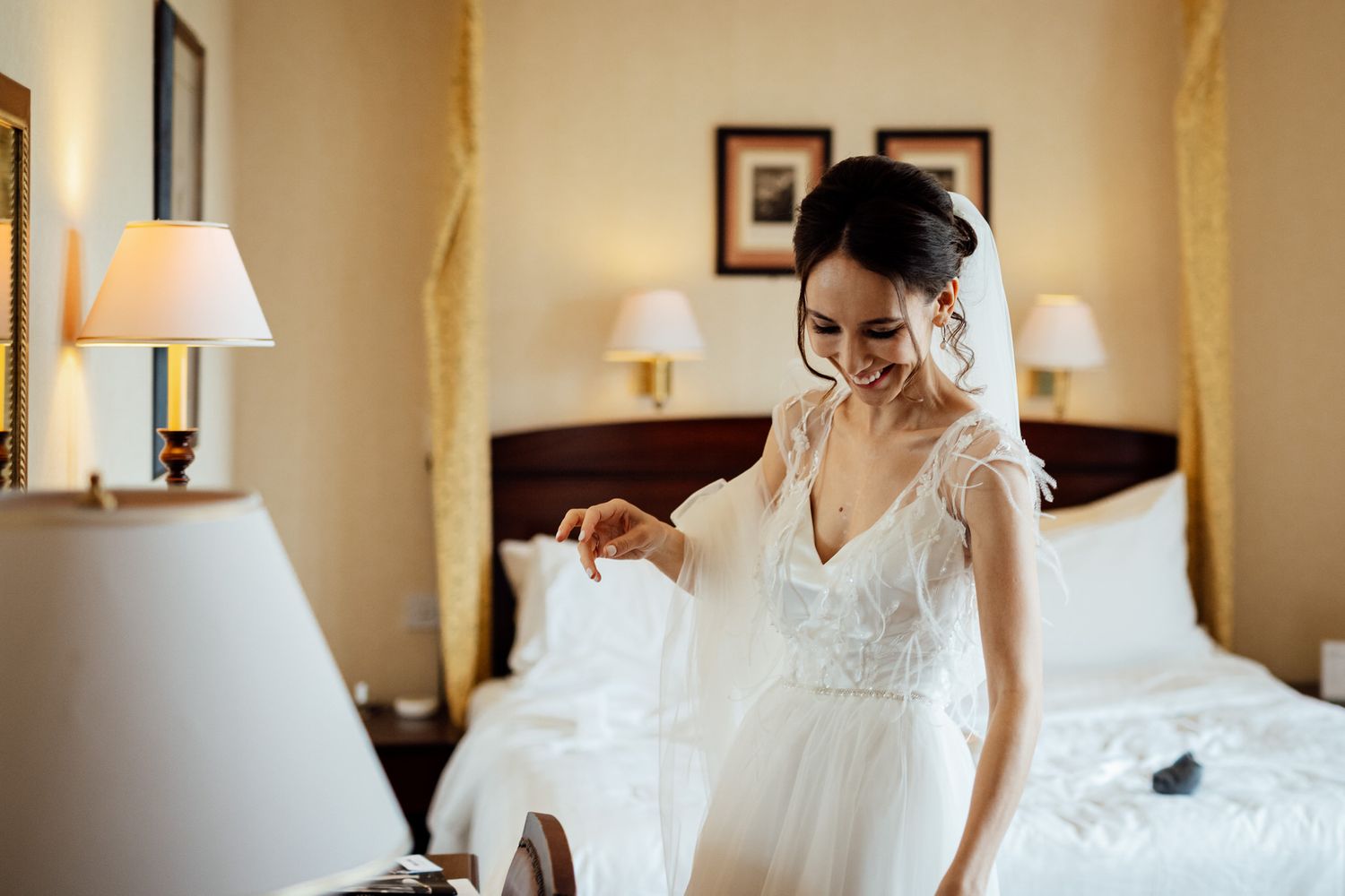 Elegant bedroom interior with warm lighting and wedding preparations.