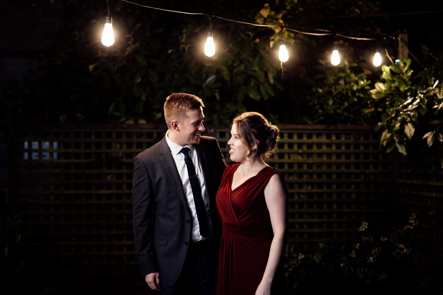 String lights illuminate an evening outdoor setting creating a romantic ambiance.
