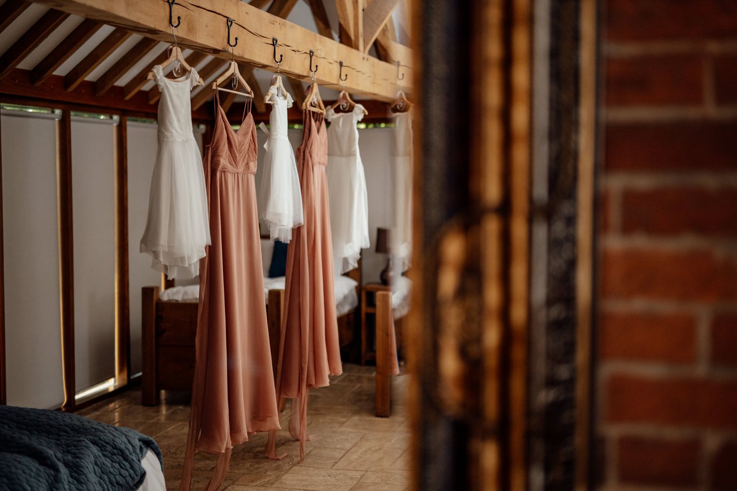 Interior view of a rustic barn venue with exposed brick walls and hanging decorations.