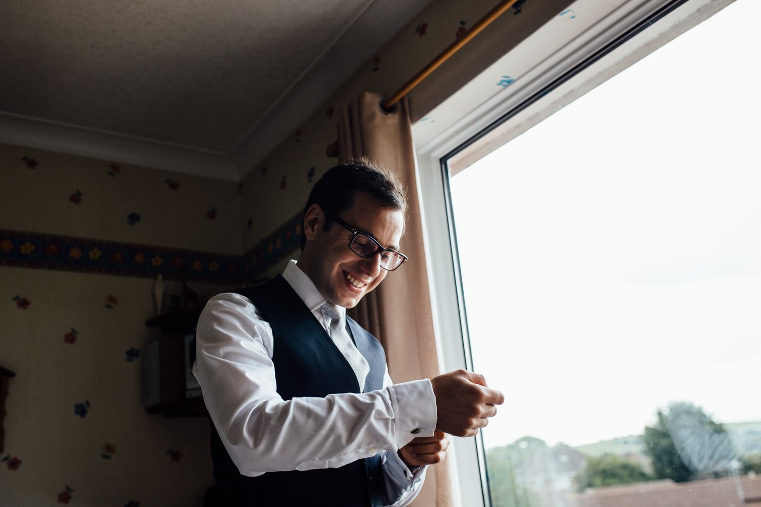 Formal attire and preparations by window with natural lighting.