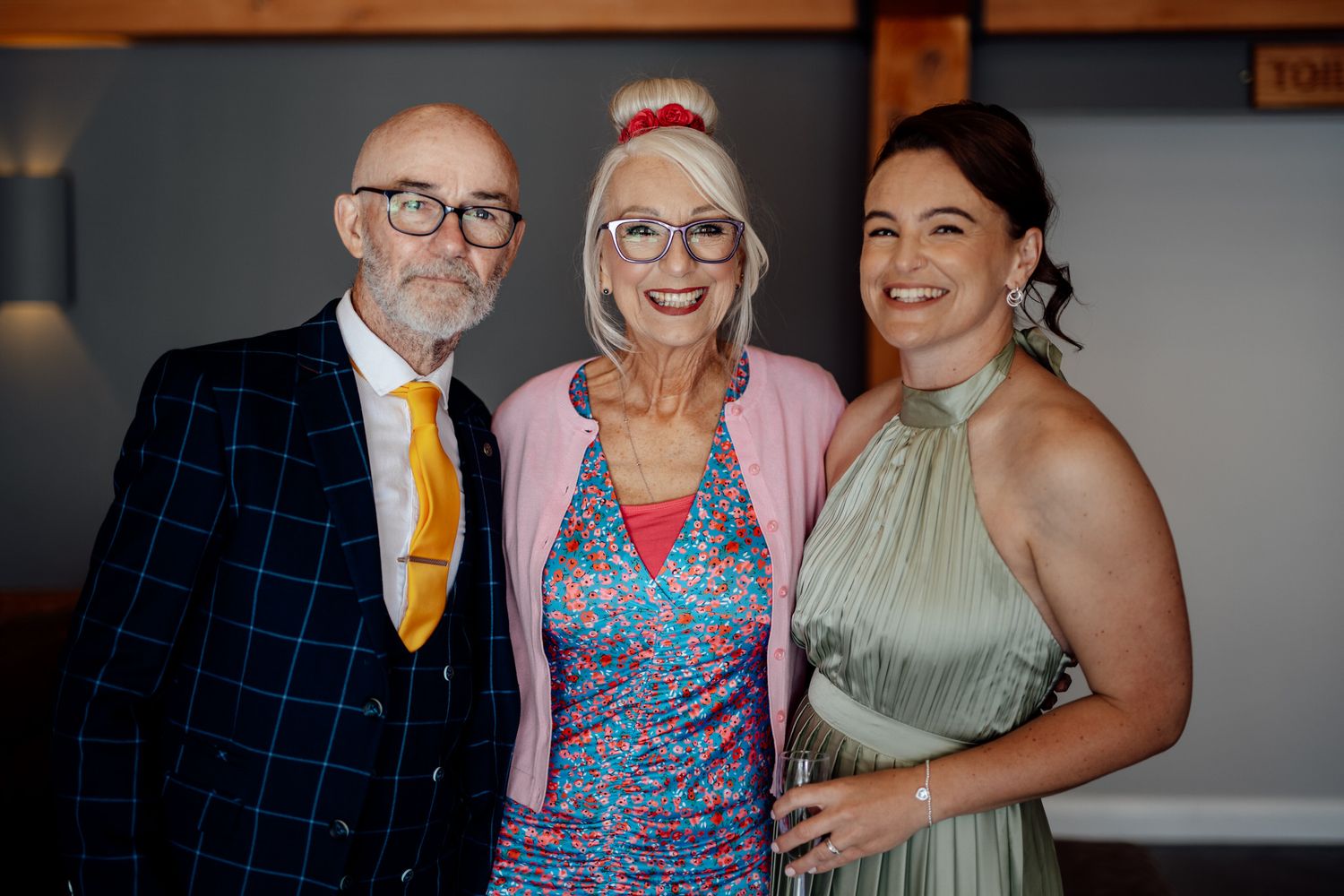 Wedding guests pose together during reception celebrations.