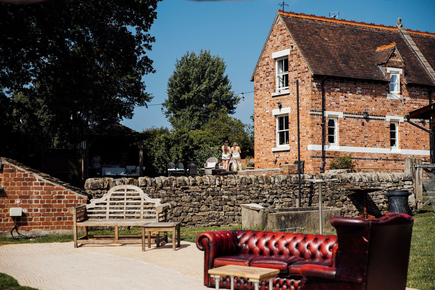 Panoramic view of rustic brick venue with outdoor seating area.