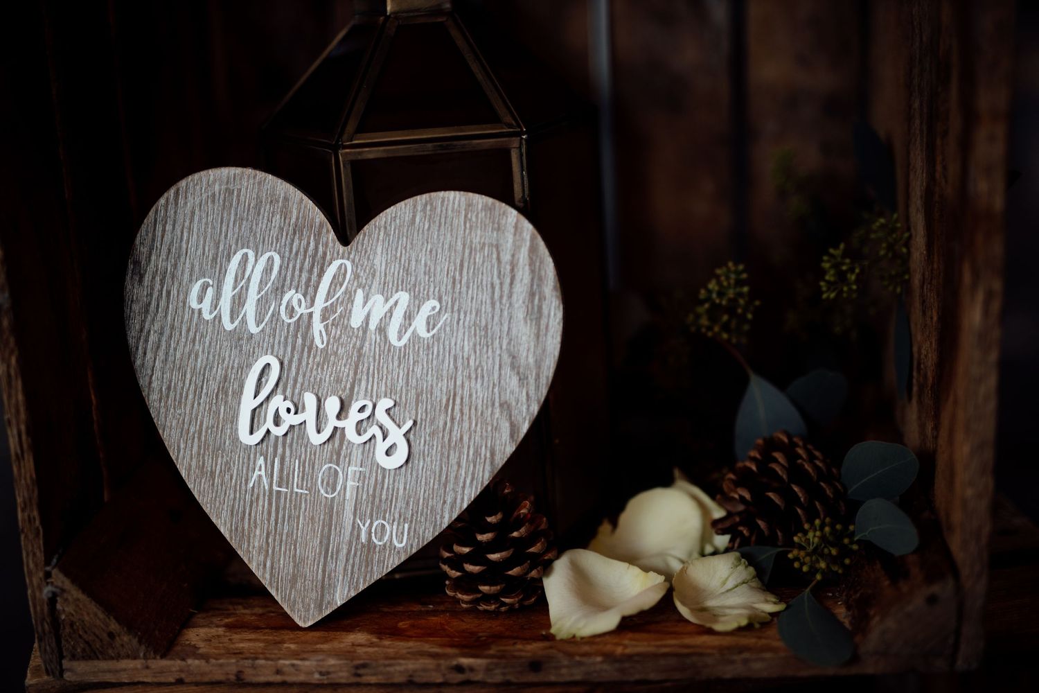 Romantic wedding decor featuring heart-shaped signs and decorative elements in rustic style.