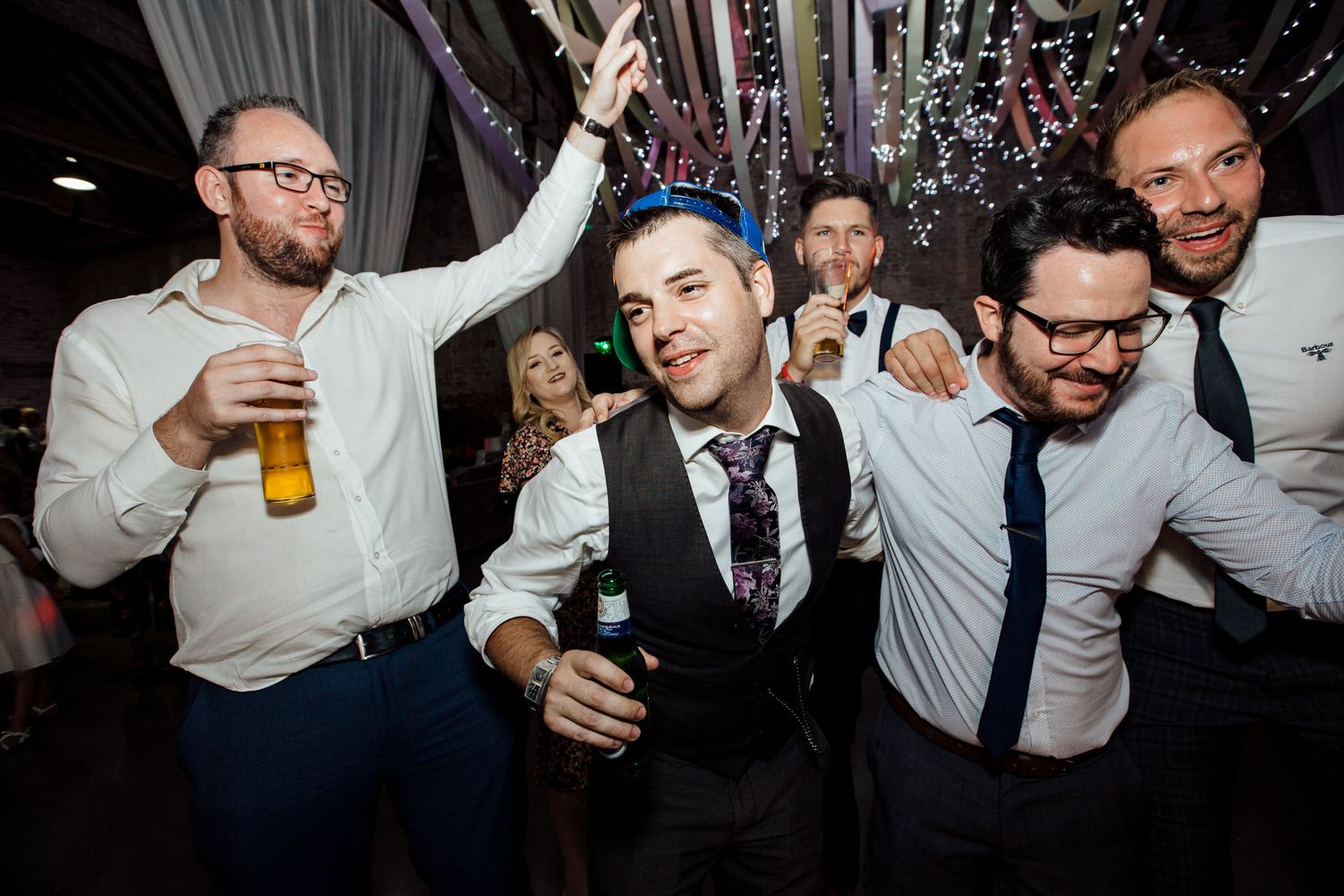 Wedding reception party with guests dancing and celebrating.