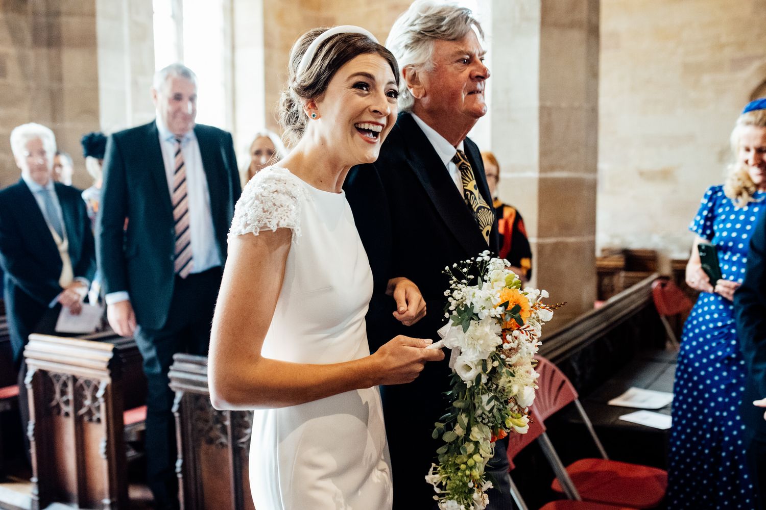Wedding celebration candids showing natural reactions and joy inside a stone church.