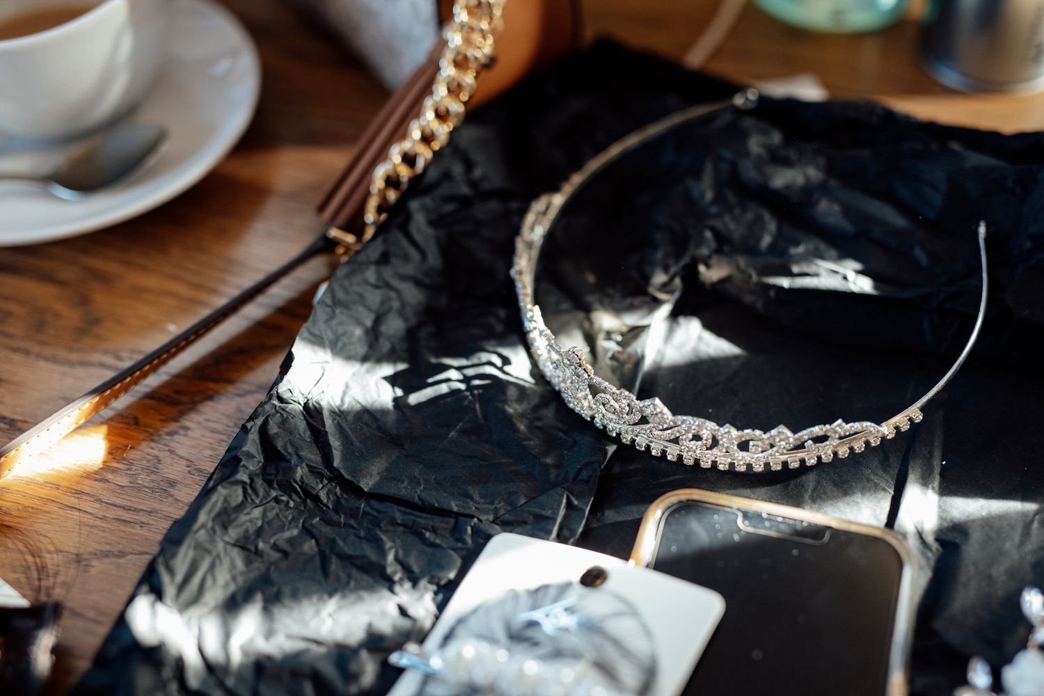Wedding accessories and details including jewelry and decor on wooden surface.