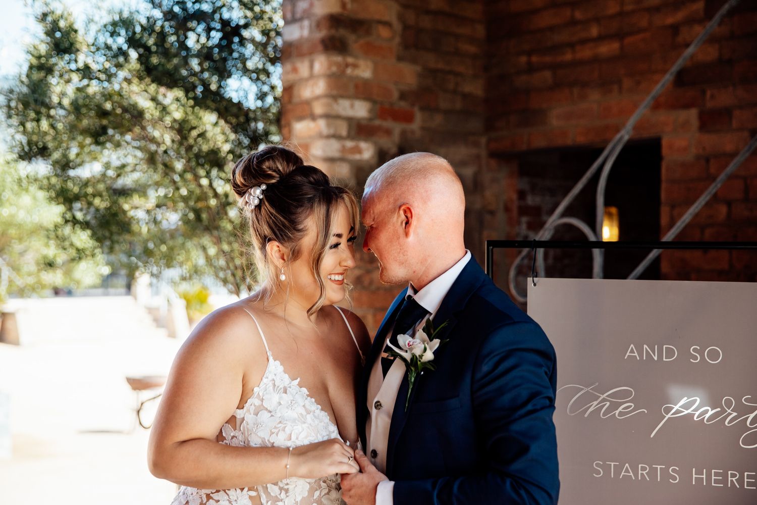 Wedding celebration moments captured in a rustic brick venue with natural lighting.