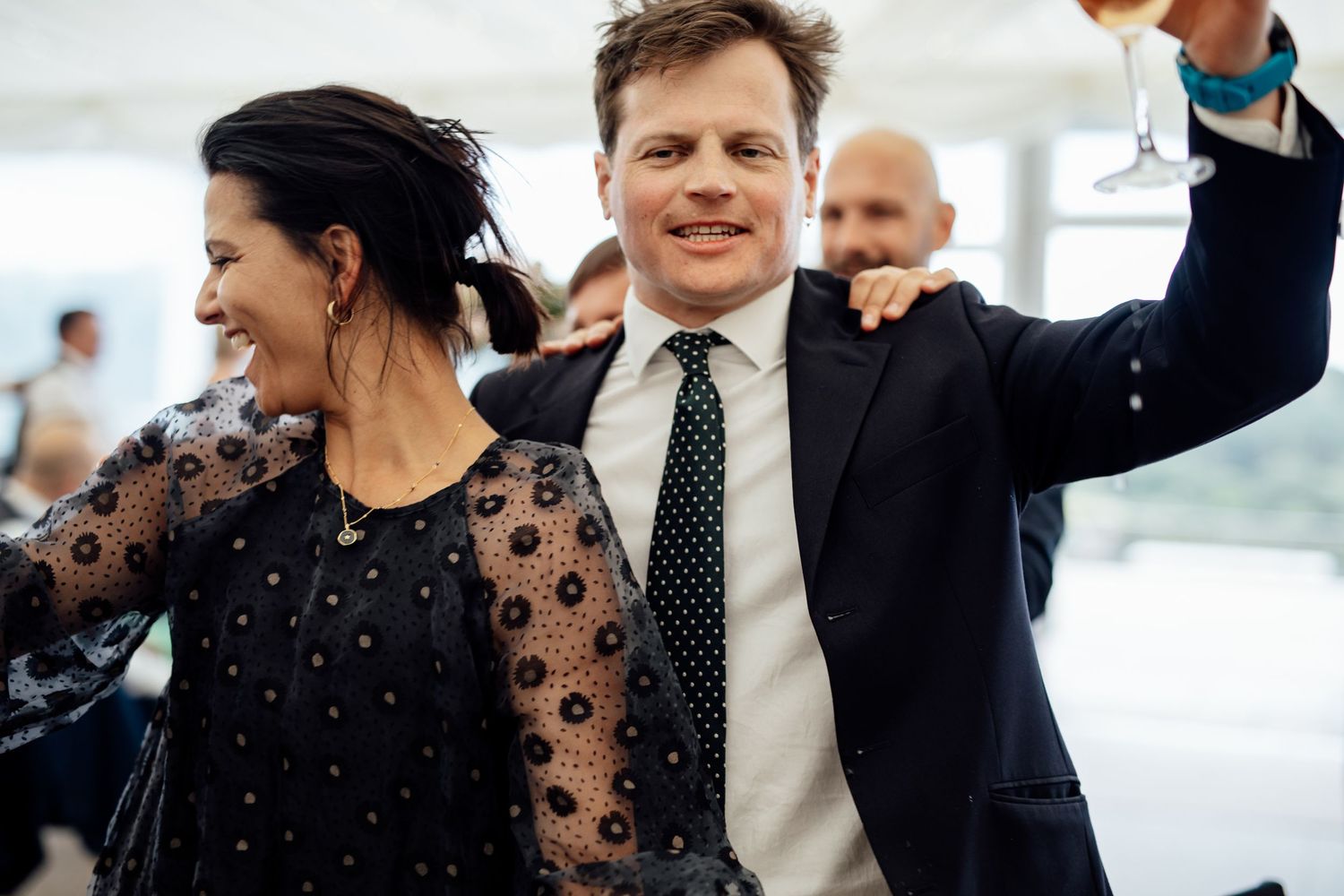 Wedding guests dancing and celebrating together at a lively reception party.