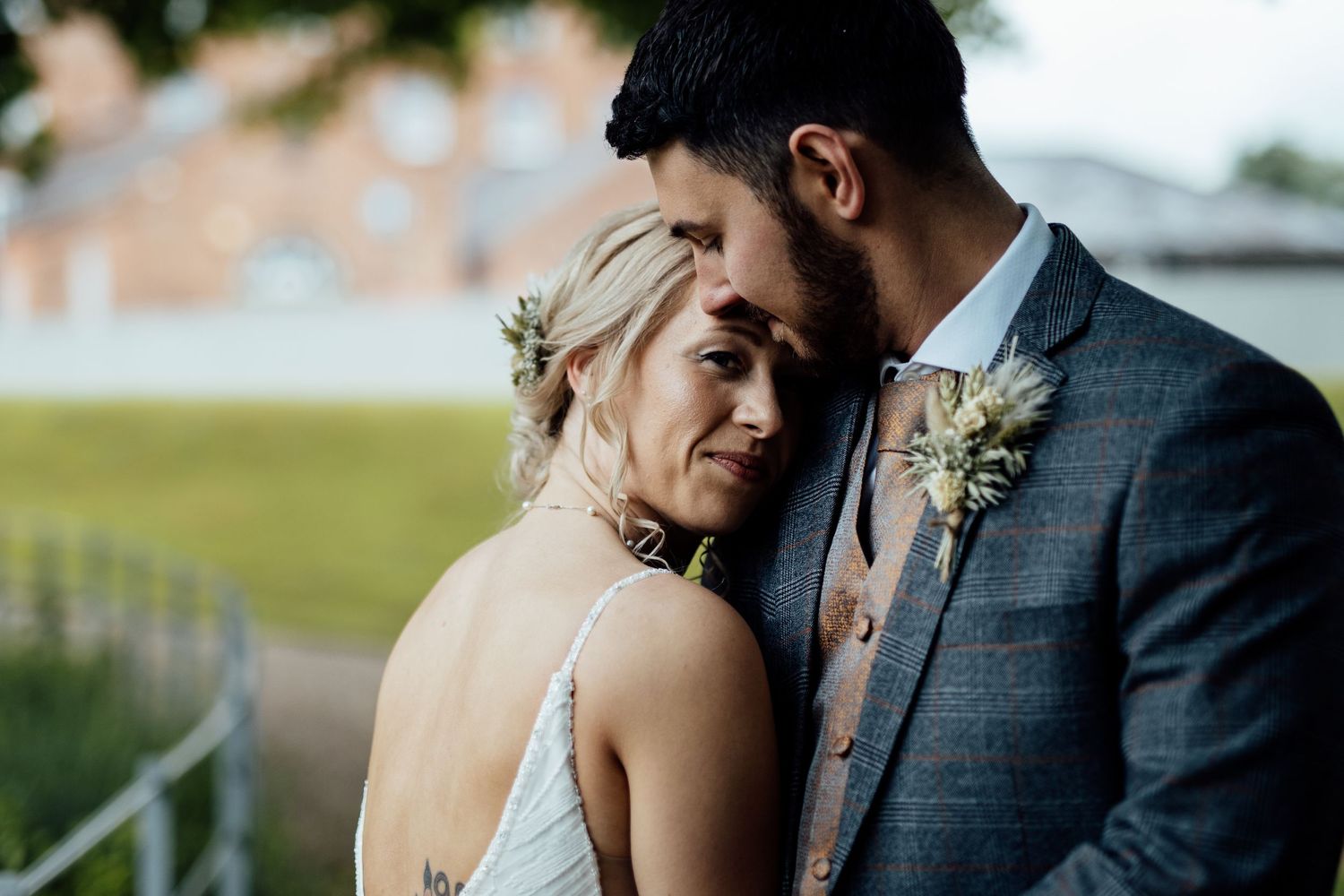 Close-up details of formal wedding attire and floral accessories.