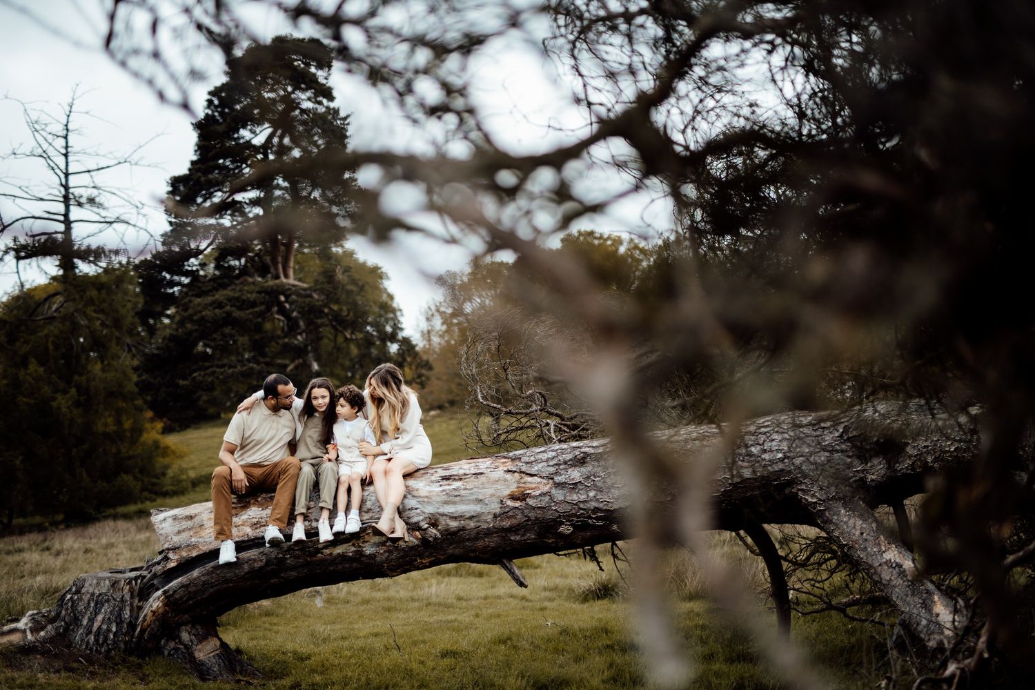 A family in coordinated white outfits walks together through a scenic outdoor setting.