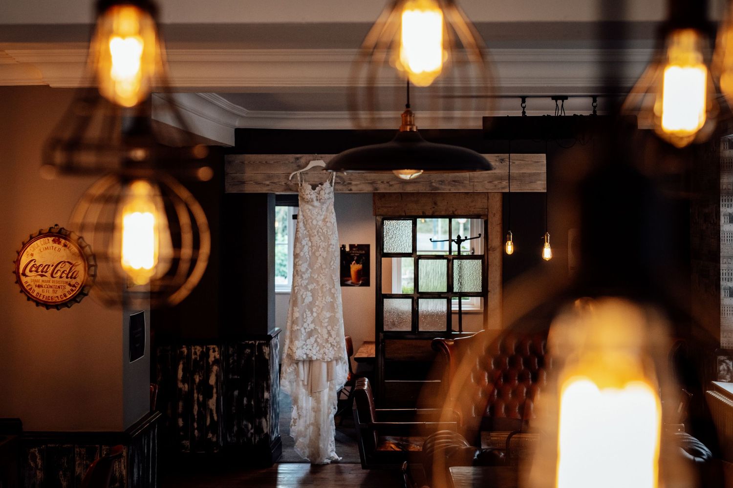 Warm glowing pendant lights hanging in a cozy restaurant interior.