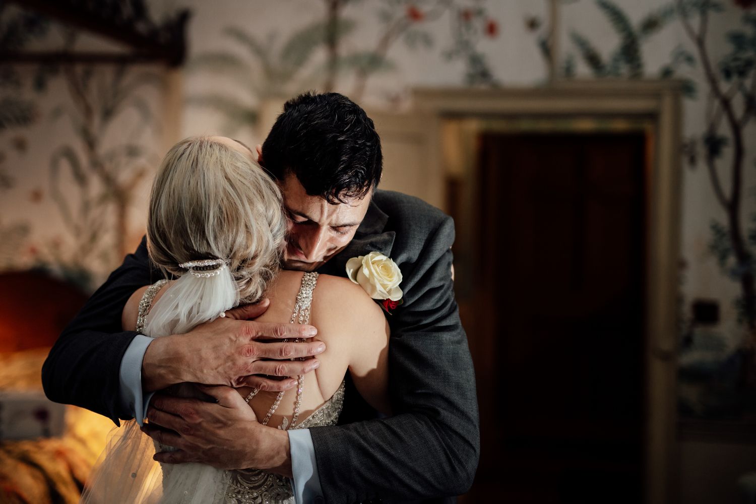 Intimate dance moments captured in a warmly lit historic venue with wallpapered walls.