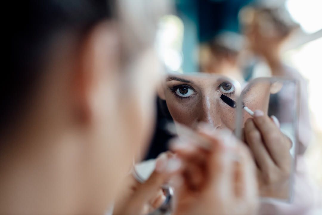 Close-up shot of eye makeup application with professional brushes.