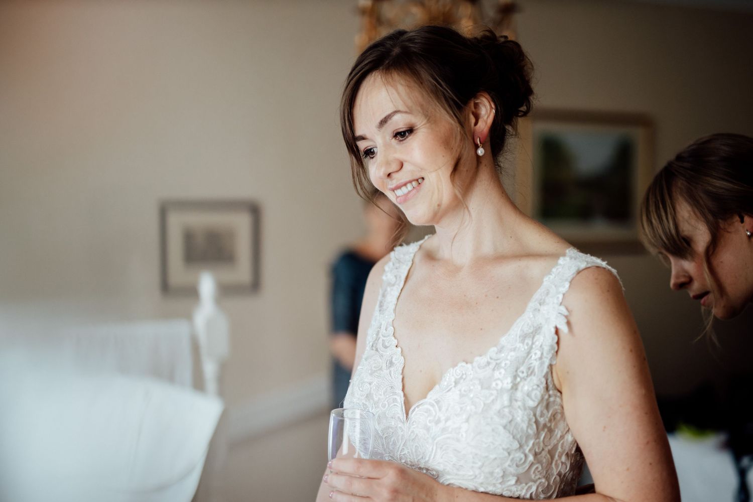 A bride in a delicate lace wedding dress gets ready on her special day.