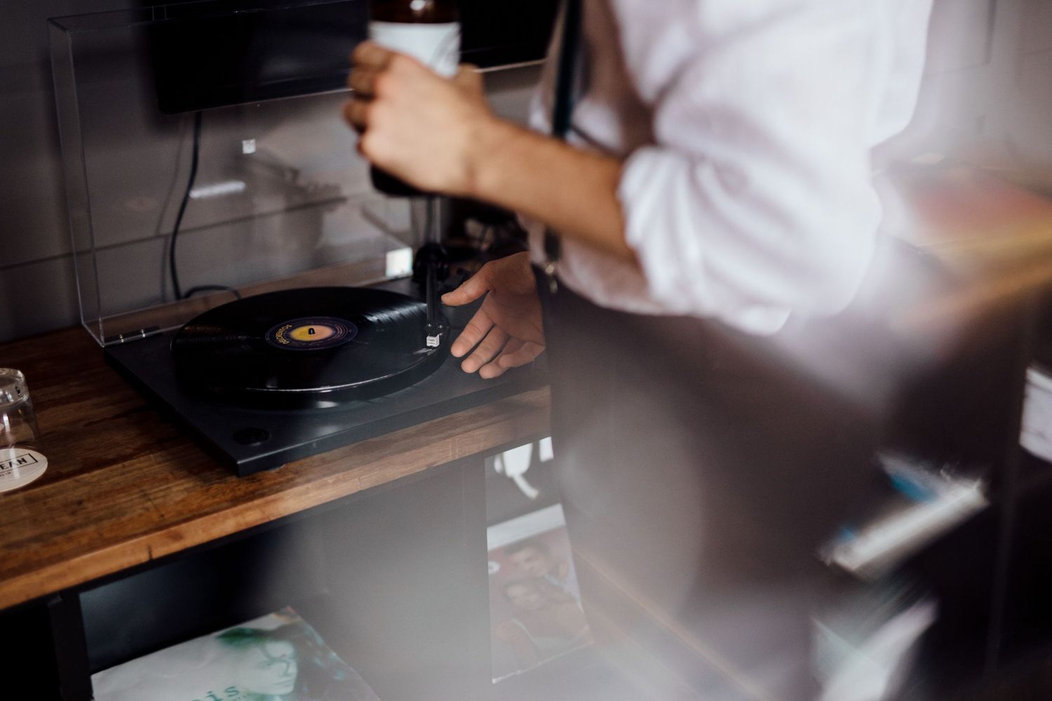 Blurred motion of hands working at a counter or desk surface.