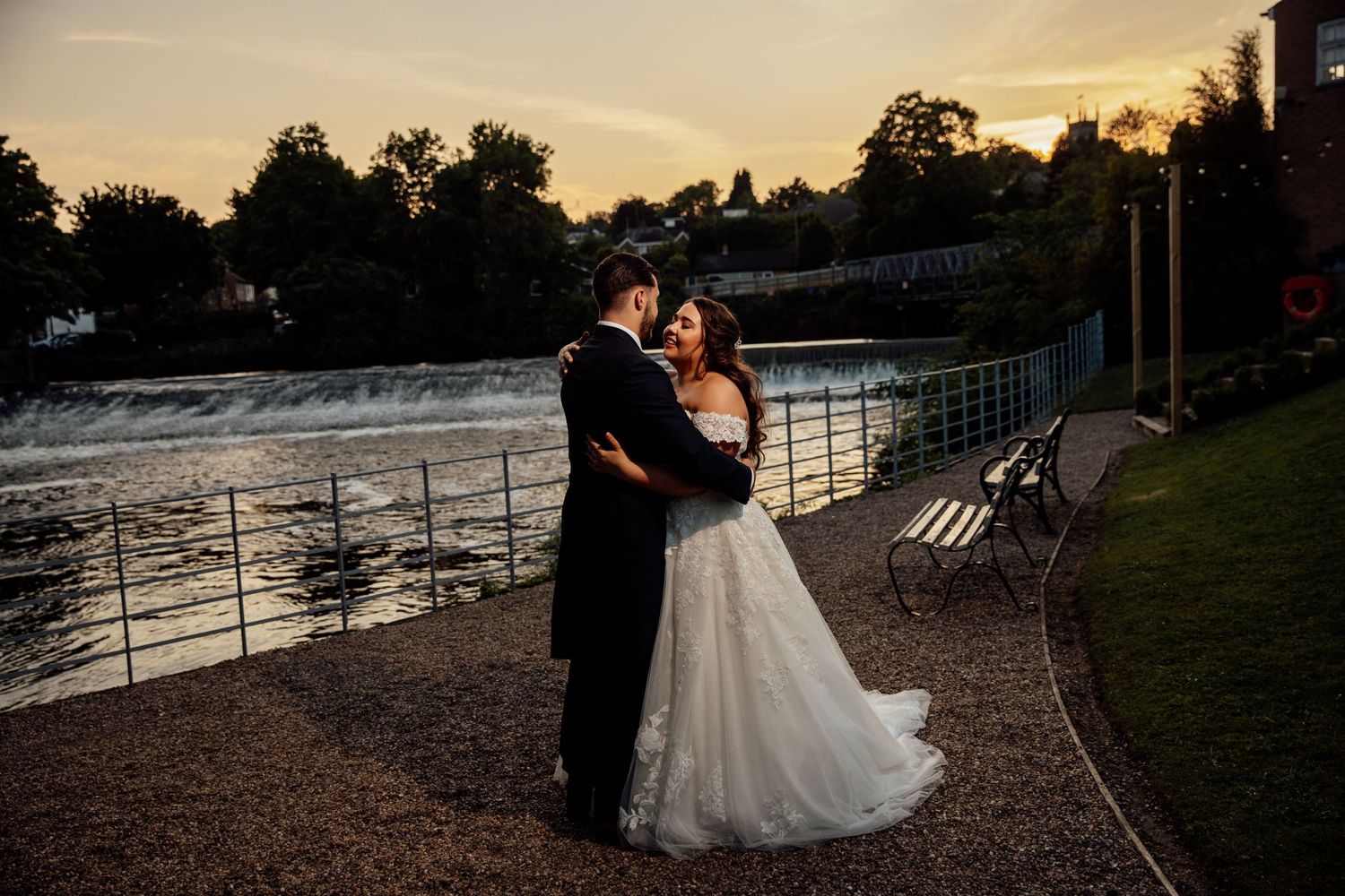 Romantic golden hour wedding portraits by the water.