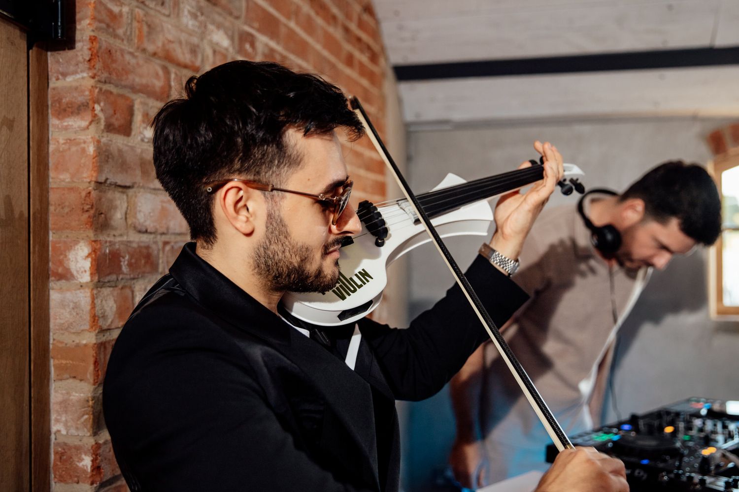 Musicians performing live music at an indoor wedding reception.