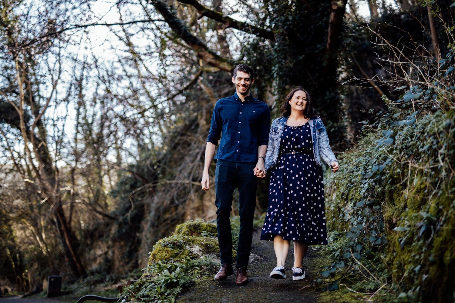 A romantic walk through a wooded park area with natural foliage and walking paths.