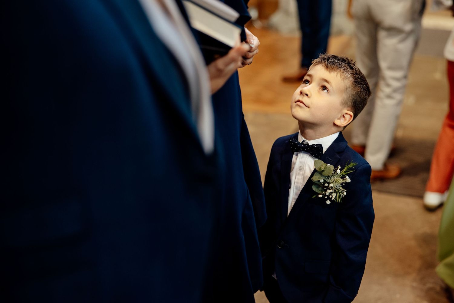Wedding ceremony moments captured in dramatic lighting within historic brick church interior.