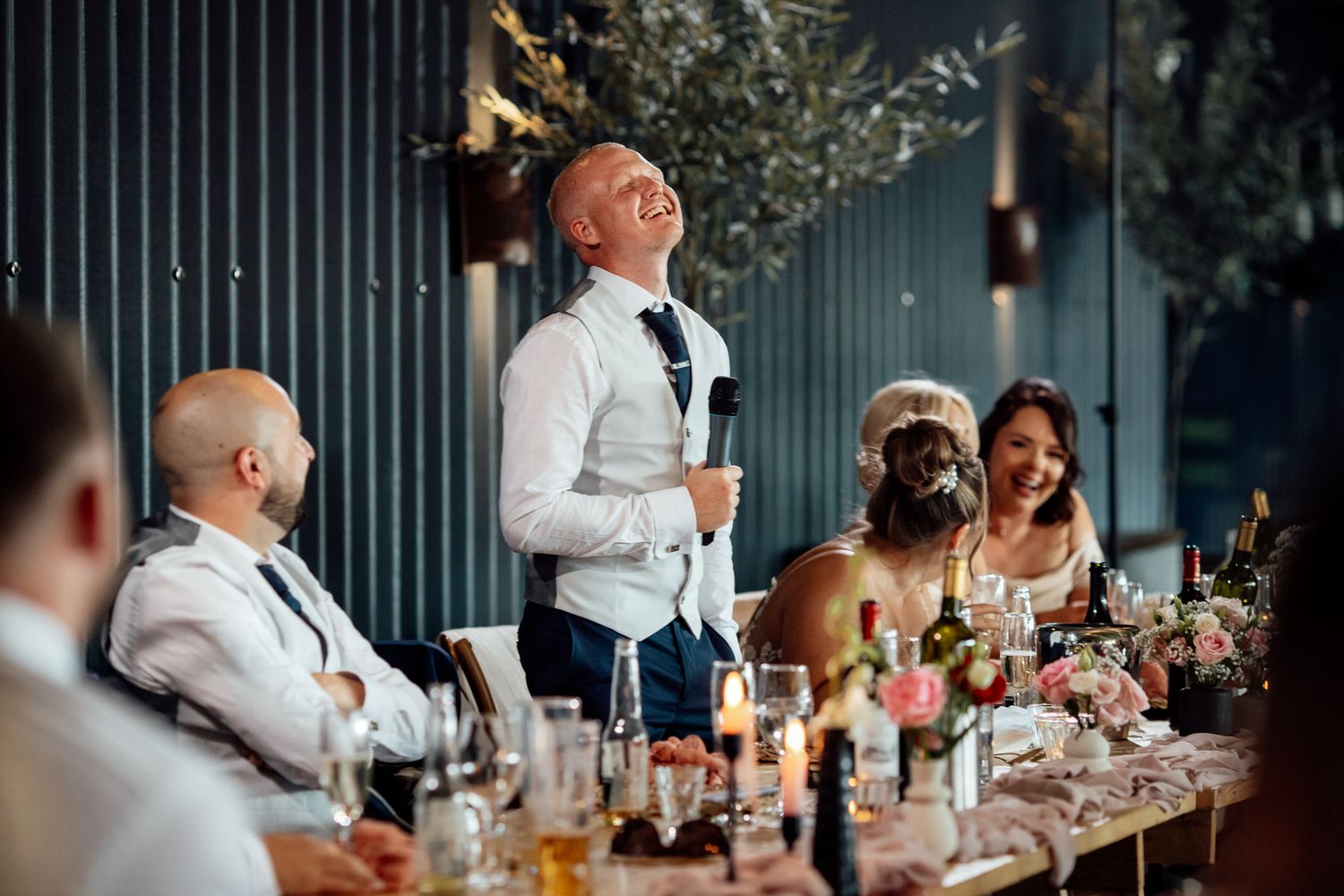 Romantic moment captured between couple at rustic wedding venue.